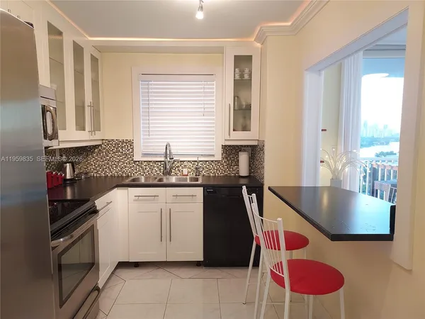 a kitchen with a stove a sink and cabinets