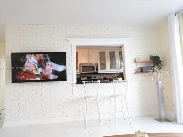 a living room with furniture and a painting on the wall