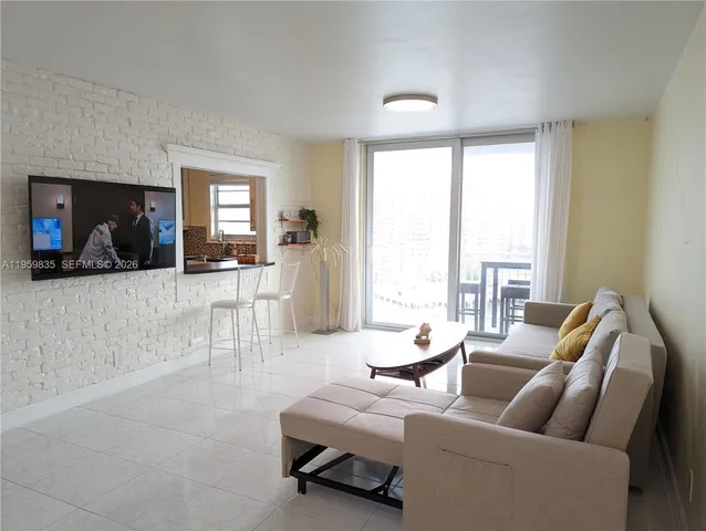 a living room with furniture and a large window