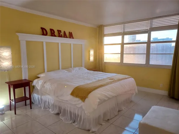 a bedroom with a bed and window