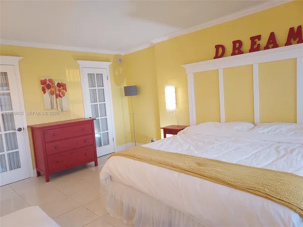 a bedroom with a bed dresser and a window