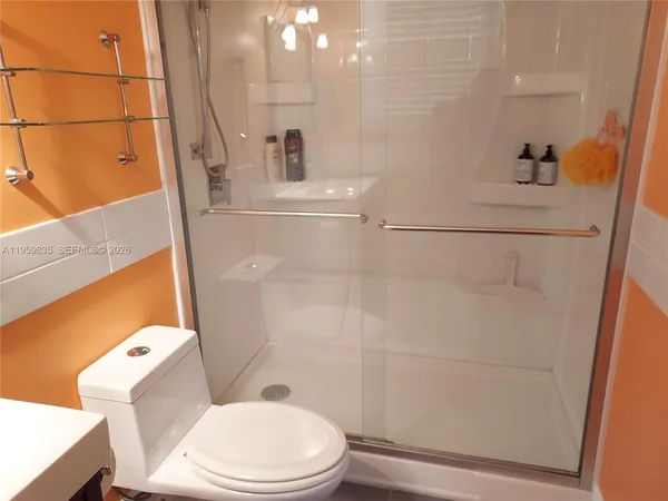a white toilet sitting next to a bathroom sink