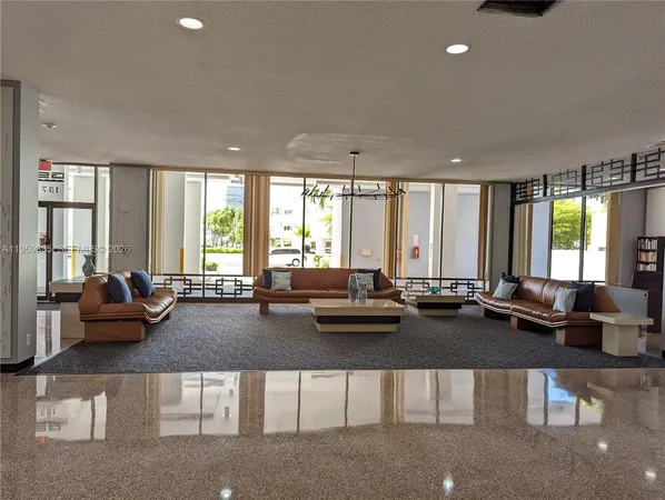 a living room with furniture and large windows