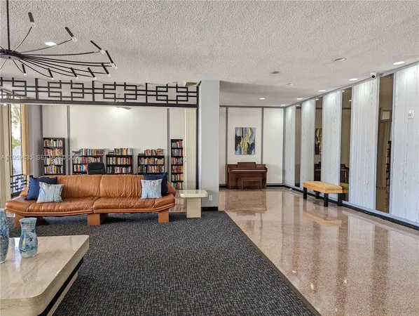a lobby with furniture and floor to ceiling window
