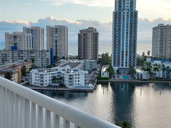 a view of lake and city with tall buildings