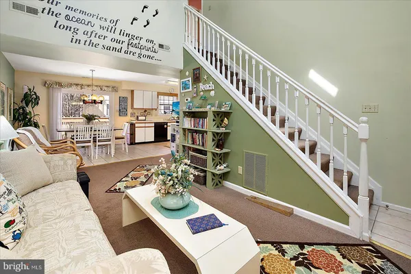 a living room with furniture and a dining table