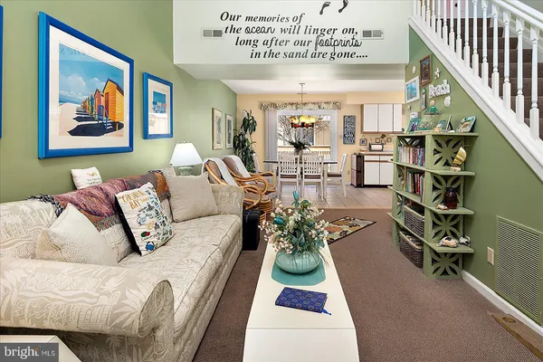 a living room with furniture flowerpot and a rug