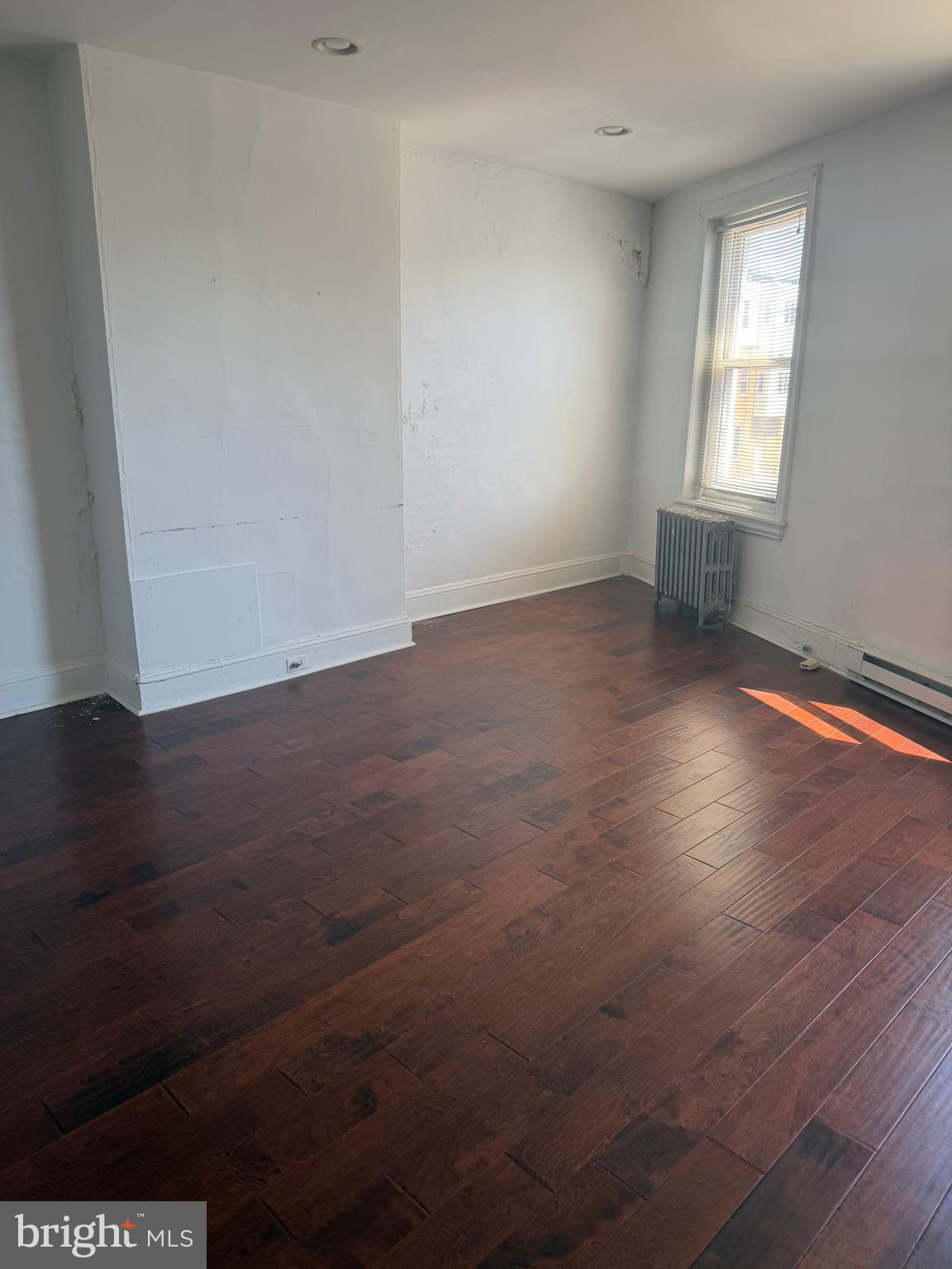 1234 Point Breeze Avenue Philadelphia, PA 19146 - Photo 4 of 15 an empty room with wooden floor and windows