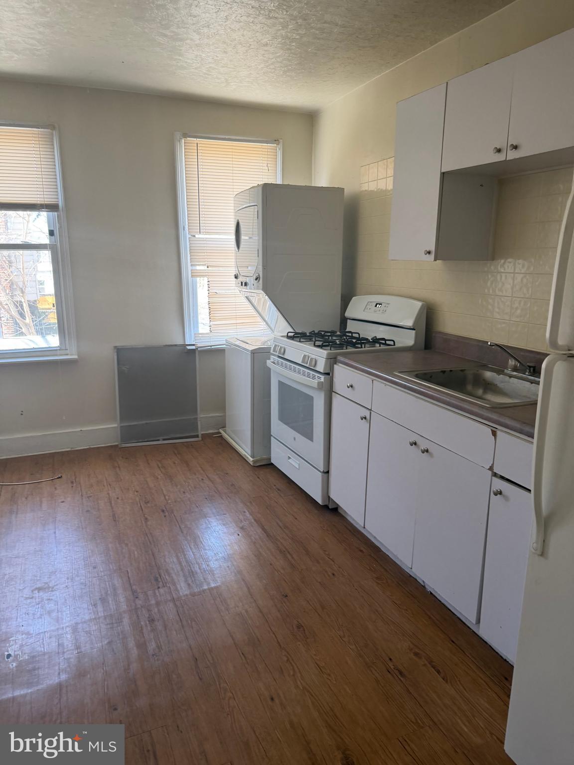 1234 Point Breeze Avenue Philadelphia, PA 19146 - Photo 6 of 15 a kitchen with granite countertop white cabinets and white appliances
