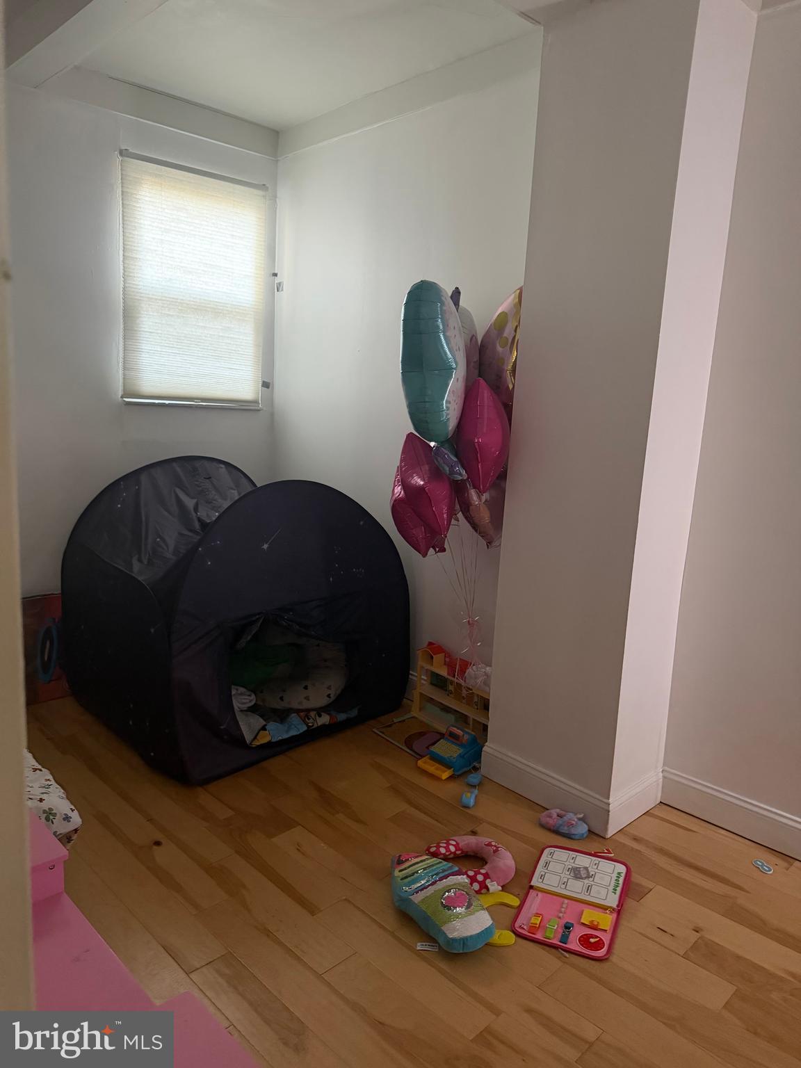 1234 Point Breeze Avenue Philadelphia, PA 19146 - Photo 9 of 15 a bedroom with a bed and wooden floor