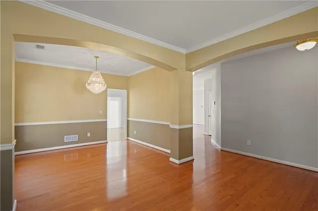 a view of a room with wooden floor