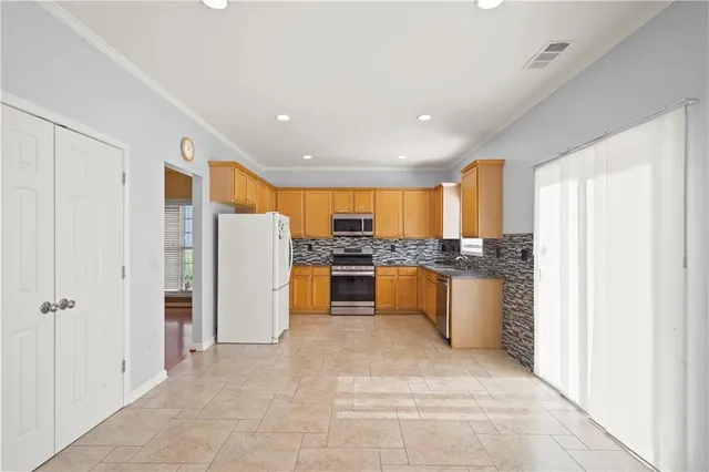 a kitchen with stainless steel appliances granite countertop a refrigerator and a sink