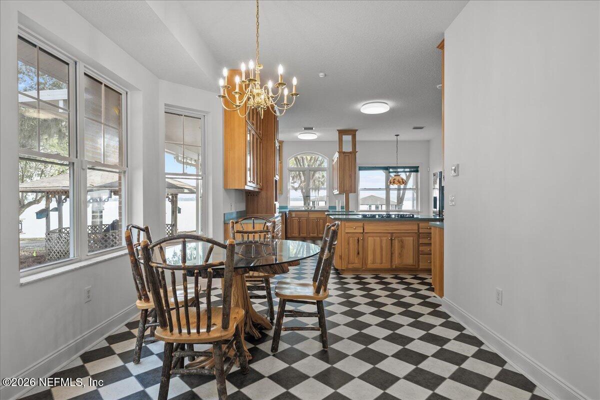 533 West River Road Palatka, FL 32177 - Photo 11 of 78 a dining room with furniture a chandelier and window