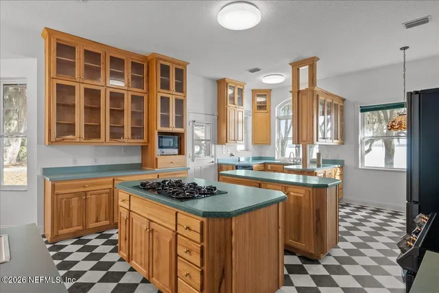 a kitchen with stainless steel appliances granite countertop a refrigerator and a stove
