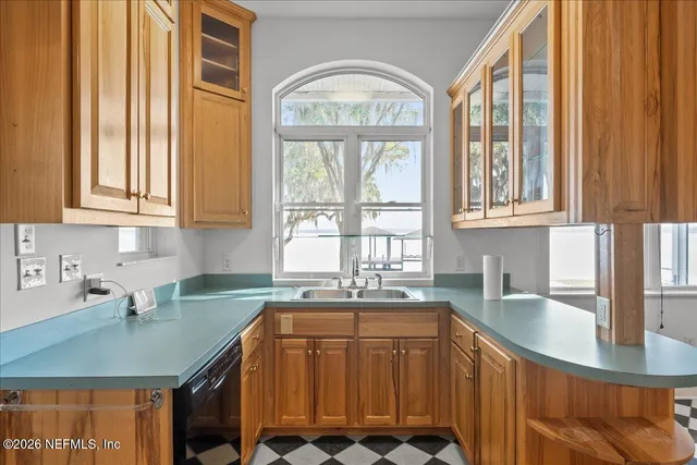 a kitchen with stainless steel appliances granite countertop a sink and a stove