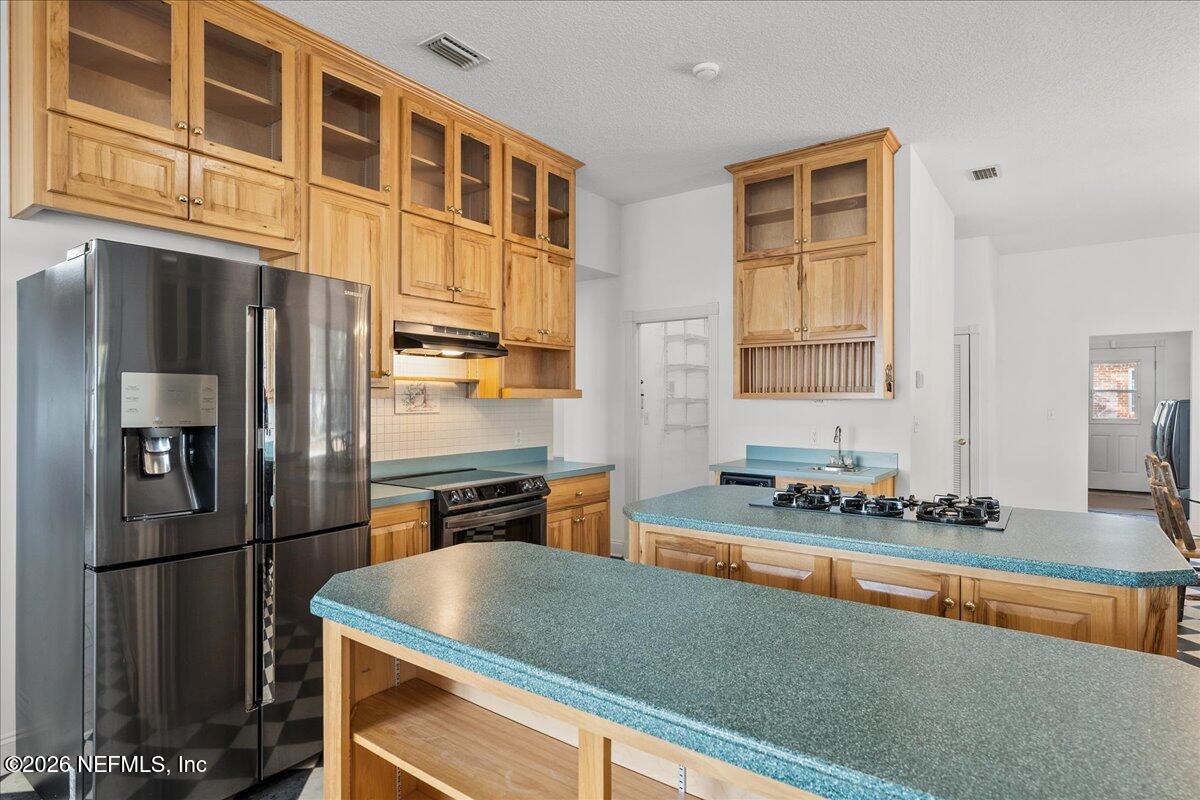 533 West River Road Palatka, FL 32177 - Photo 15 of 78 a kitchen with stainless steel appliances granite countertop a refrigerator and a stove