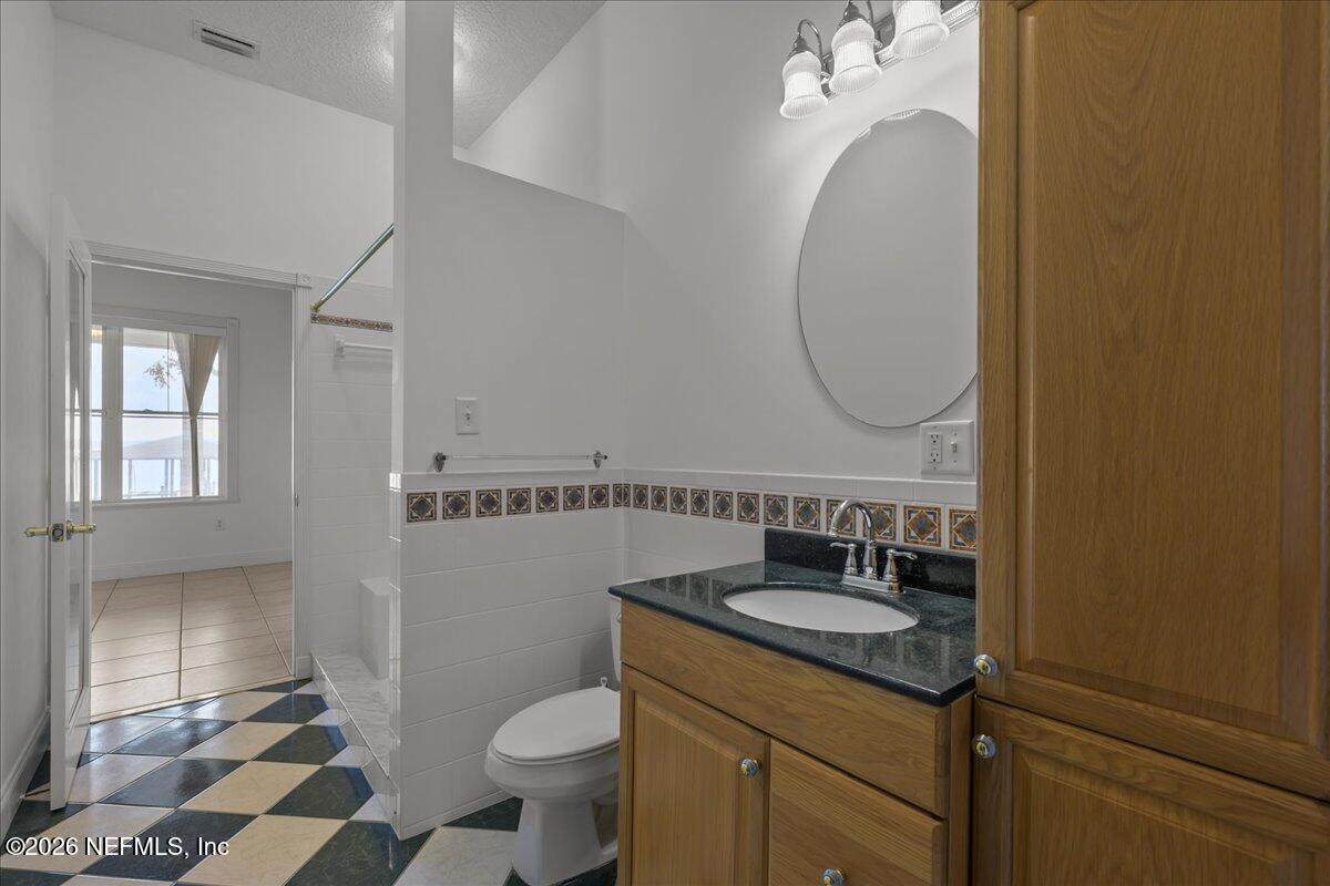 533 West River Road Palatka, FL 32177 - Photo 25 of 78 a bathroom with a granite countertop sink toilet and a mirror