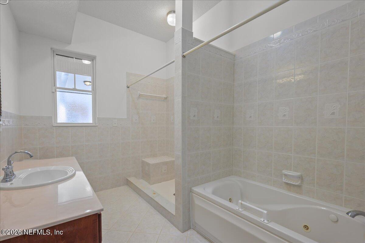 533 West River Road Palatka, FL 32177 - Photo 28 of 78 a white bath tub sitting next to a white sink and vanity