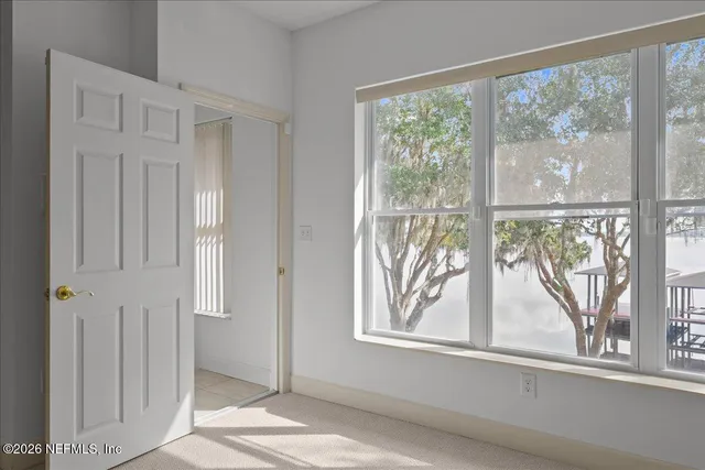 a view of a livingroom with a furniture and a large window