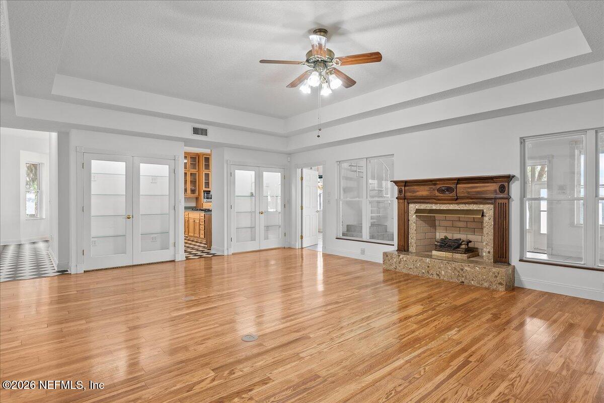 533 West River Road Palatka, FL 32177 - Photo 9 of 78 wooden floor fireplace and windows in an empty room