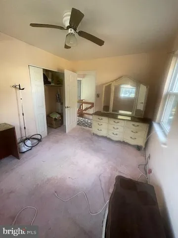 a view of a livingroom with furniture and a ceiling fan