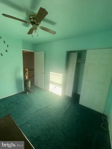 a view of empty room with fan and window