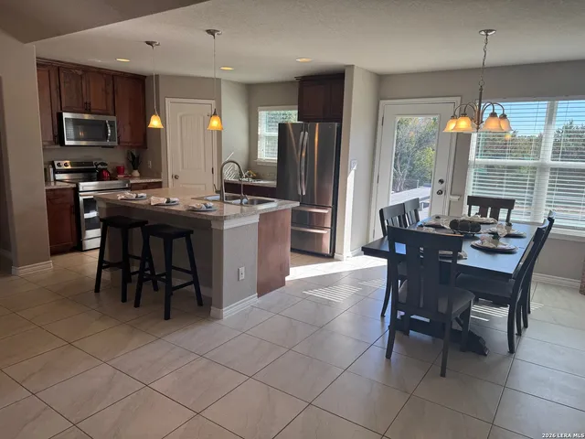 a dining room with furniture and window