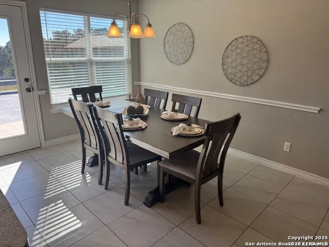 a view of a dining room with furniture and a window