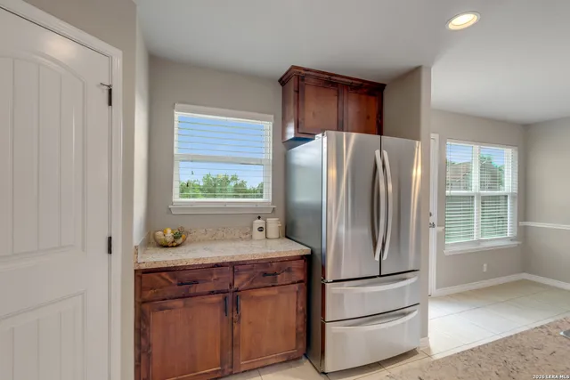 a kitchen with stainless steel appliances granite countertop a refrigerator and a sink