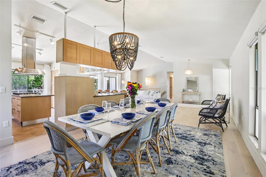 3390 Bayou Sound Longboat Key, FL 34228 - Photo 6 of 59 a view of a dining room with furniture a chandelier and wooden floor