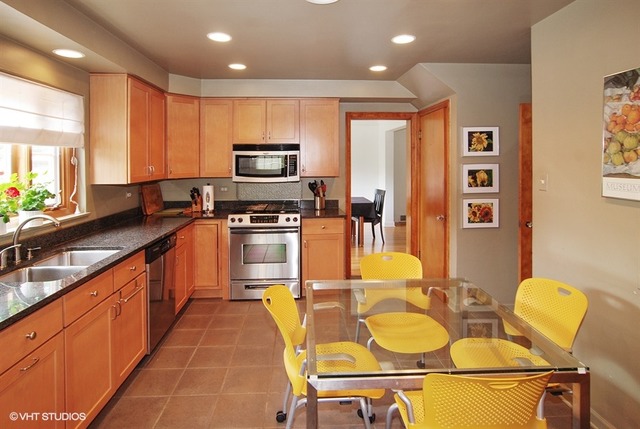 505 Nuttall Road Riverside, IL 60546 - Photo 4 of 15 a large kitchen with stainless steel appliances granite countertop a sink counter space and a dining table