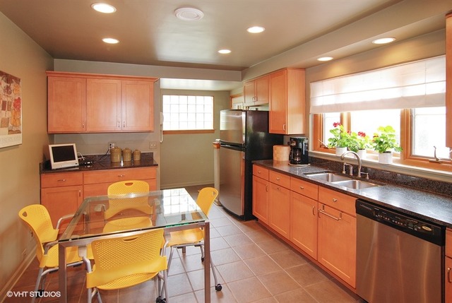 505 Nuttall Road Riverside, IL 60546 - Photo 5 of 15 a large kitchen with lots of counter space that has a sink and chairs