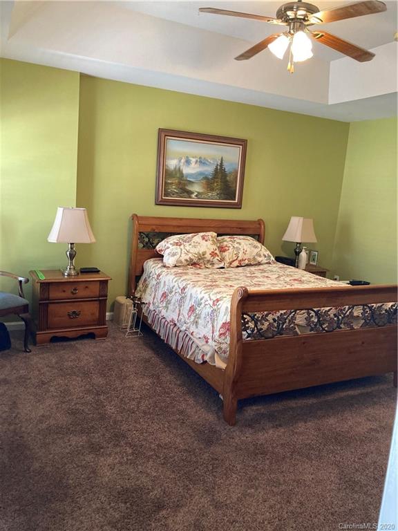 849 Dillard Road Rock Hill, SC 29730 - Photo 22 of 28 a bedroom with a bed and a chandelier