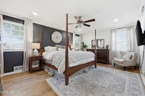 a bed room with a bed mirror and a window