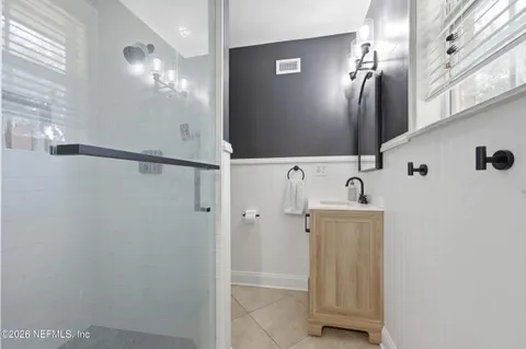 a bathroom with a shower and a mirror