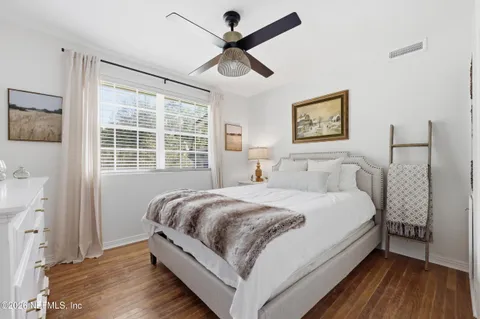 a large bedroom with a bed and a window