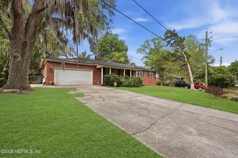 a front view of house with yard and green space