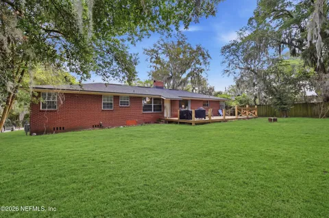 a front view of house with yard and green space