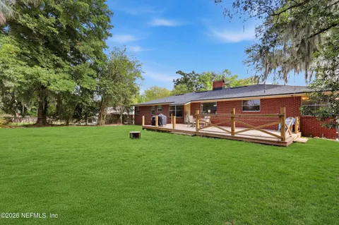 a view of a house with backyard sitting area and garden