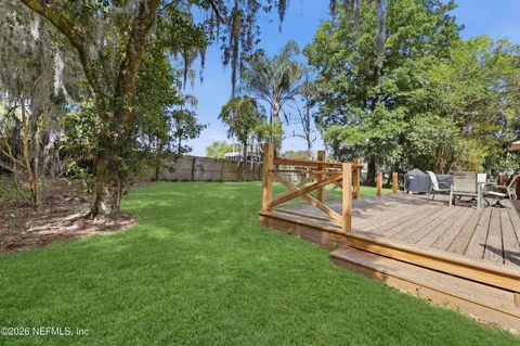 a view of a backyard with sitting area