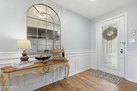 a kitchen with a stove and a wooden floor