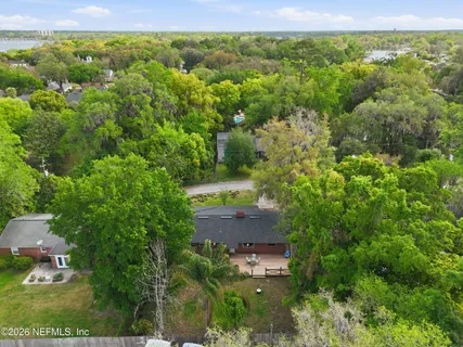 an aerial view of a house with a yard