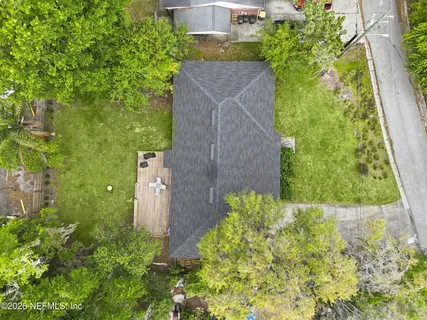 a aerial view of a house with a yard and garden