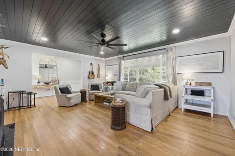 a living room with furniture and wooden floor