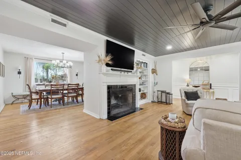 a living room with furniture a fireplace and a flat screen tv
