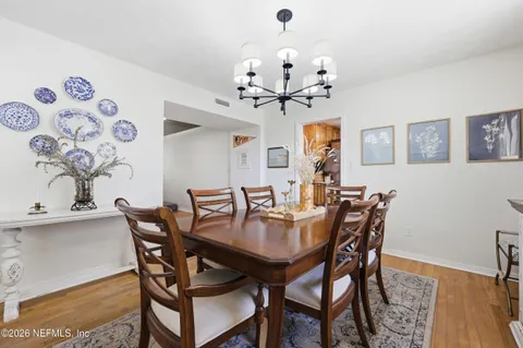 a view of a dining room with furniture and wooden floor