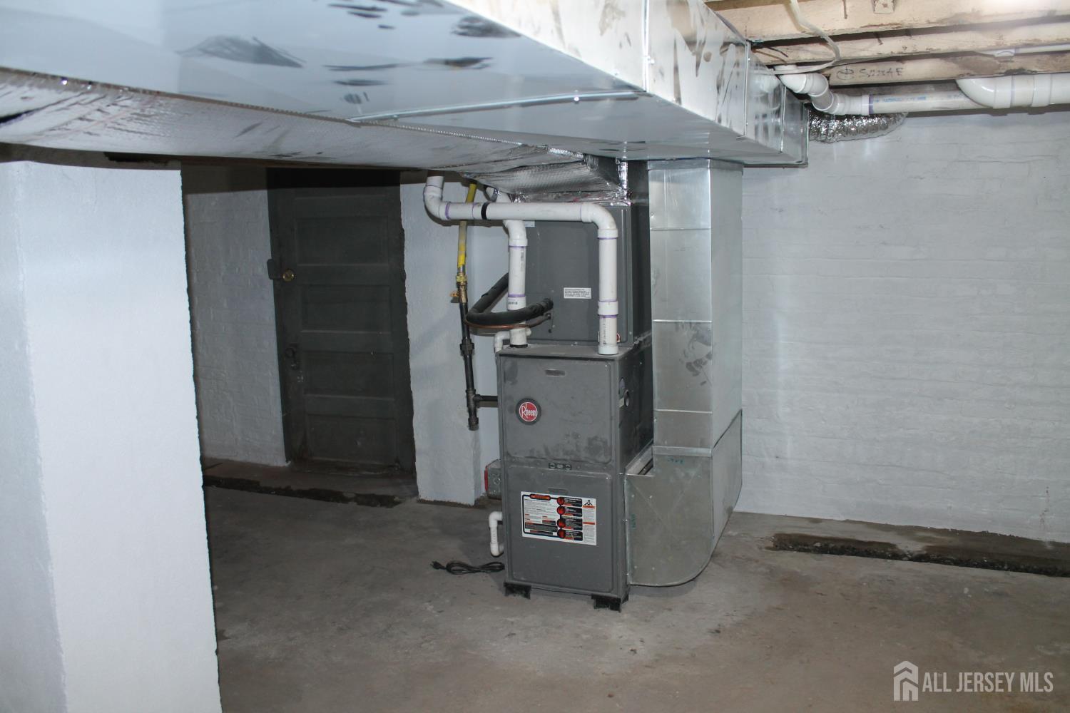 519 Roosevelt Avenue, Unit 2 Carteret, NJ 07008 - Photo 15 of 17 a room with water heater and a cabinet
