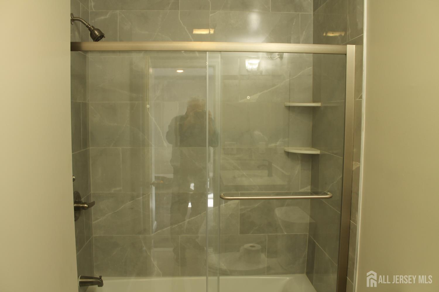 519 Roosevelt Avenue, Unit 2 Carteret, NJ 07008 - Photo 4 of 17 a bathroom with a glass shower door