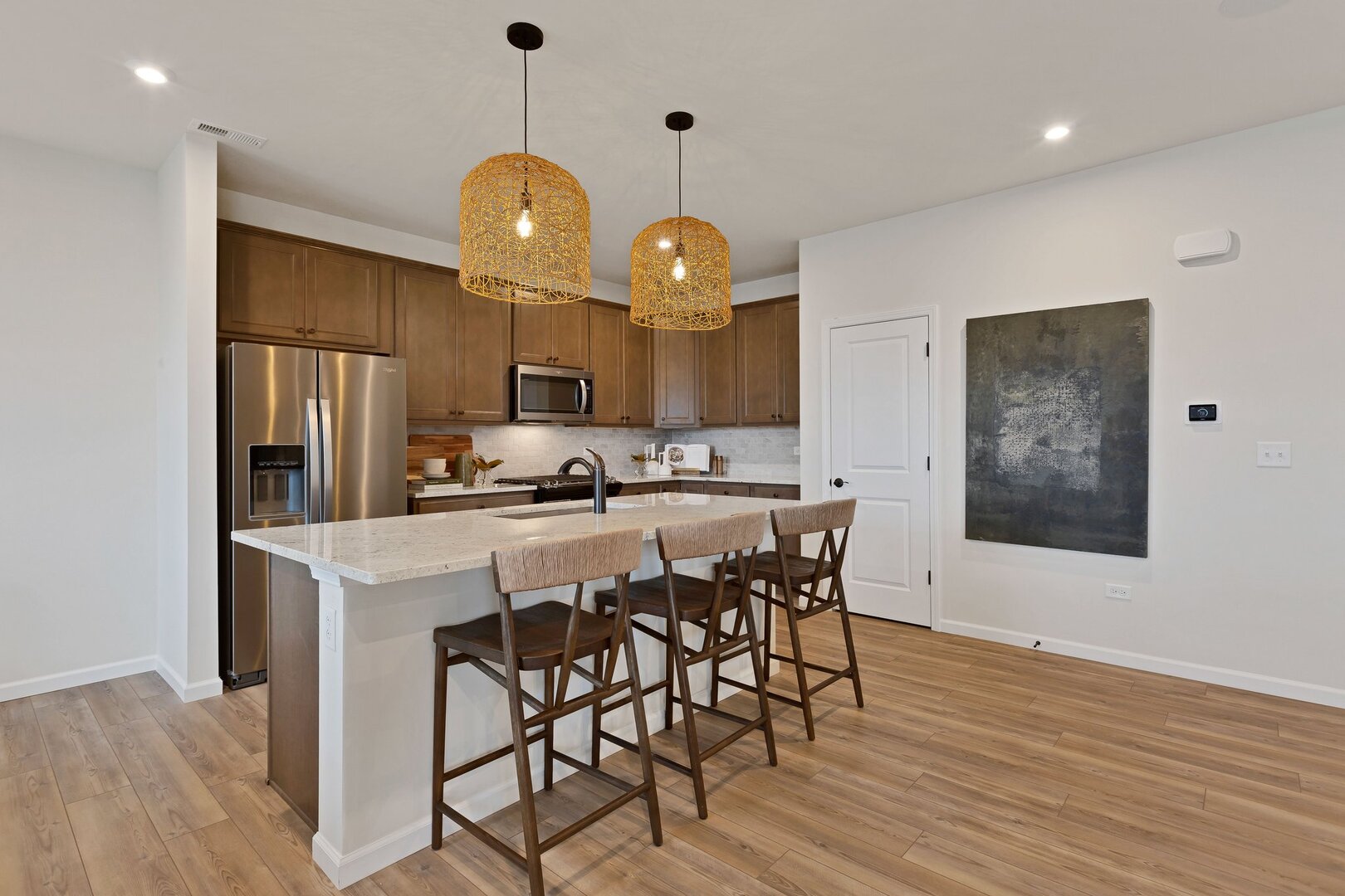 2539 Tailshot Road Plainfield, IL 60585 - Photo 2 of 14 a kitchen with stainless steel appliances a dining table chairs and wooden floor