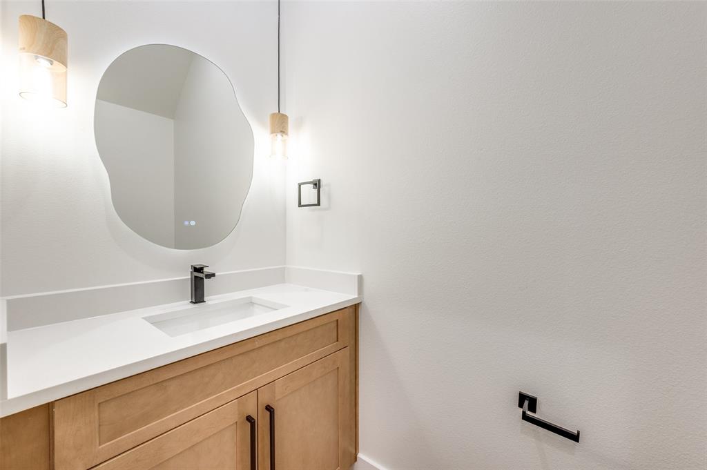 407 Bobbie Street Dallas, TX 75203 - Photo 14 of 25 a bathroom with a sink and a mirror
